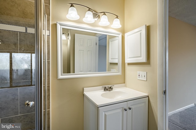 bathroom with vanity, an enclosed shower, and a textured ceiling