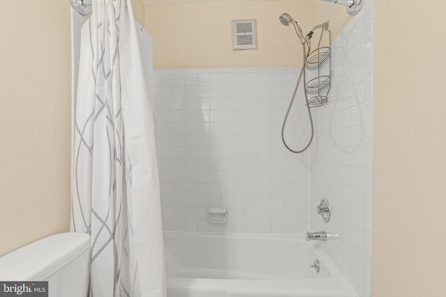 bathroom with shower / bath combo and toilet