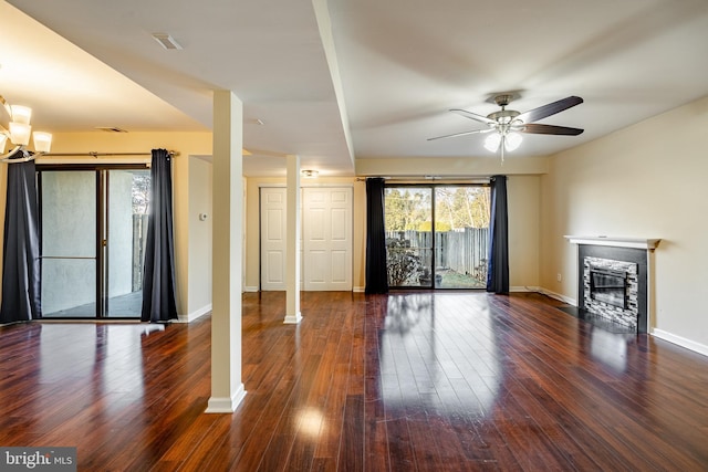 unfurnished living room featuring ceiling fan and dark hardwood / wood-style flooring