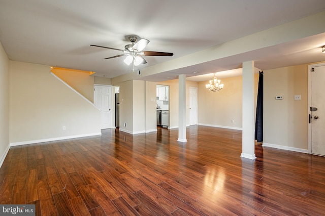 unfurnished living room featuring ceiling fan with notable chandelier and dark hardwood / wood-style flooring