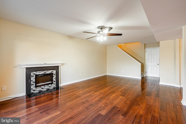 unfurnished living room featuring ceiling fan and dark wood-type flooring