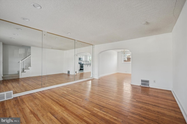 interior space with hardwood / wood-style flooring and a textured ceiling