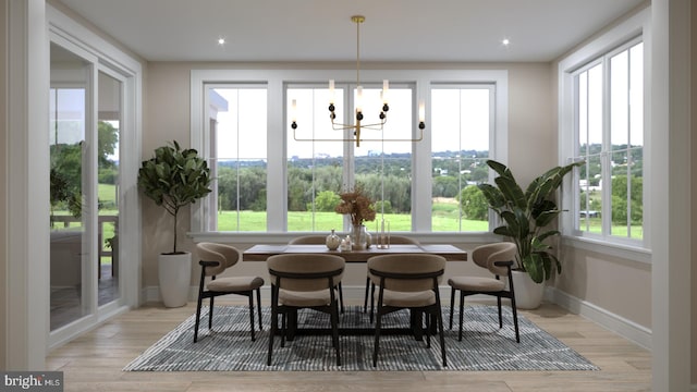 sunroom featuring a chandelier