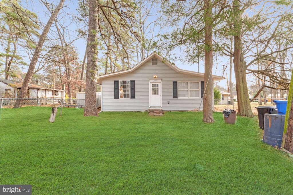 rear view of house with a lawn