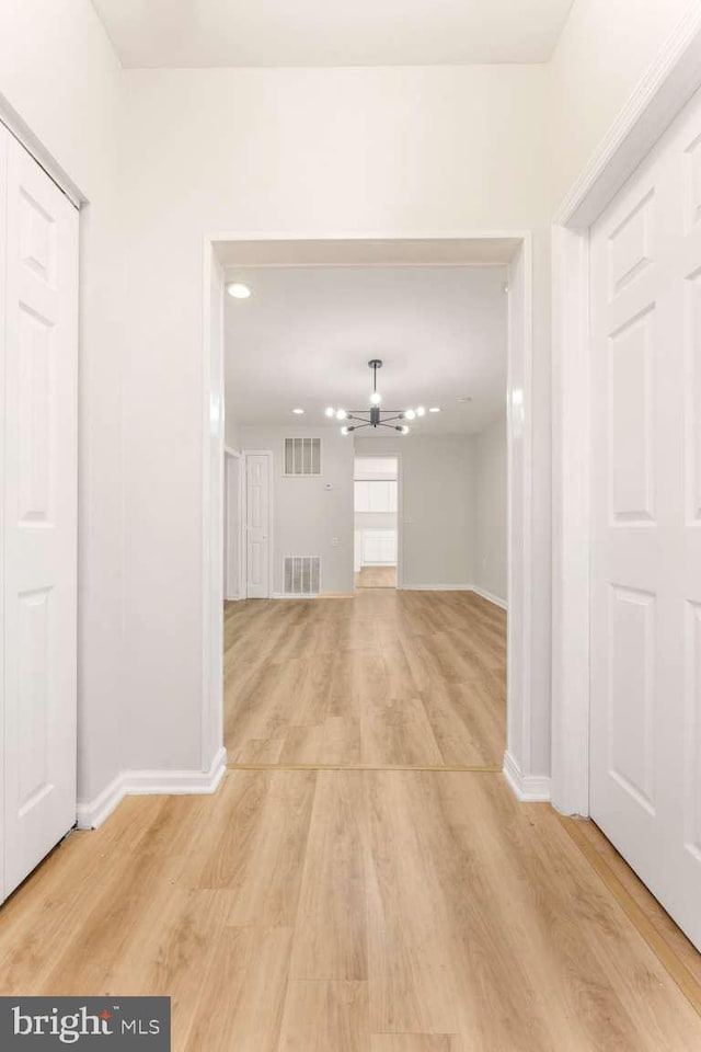 hall with light hardwood / wood-style flooring