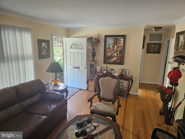 living room featuring light hardwood / wood-style floors and ornamental molding