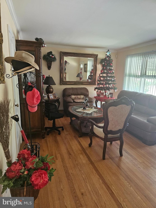 dining space featuring crown molding and hardwood / wood-style floors