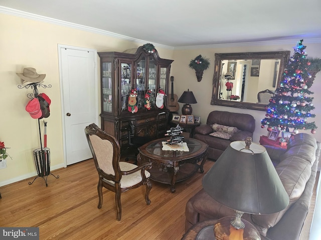 living room with hardwood / wood-style flooring and ornamental molding