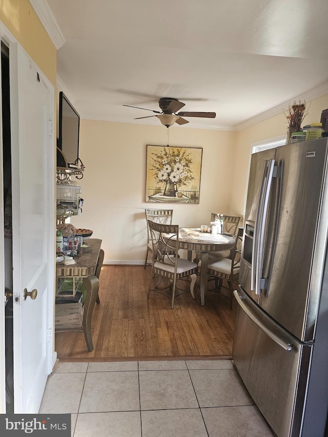 dining room with ceiling fan, light hardwood / wood-style floors, and ornamental molding