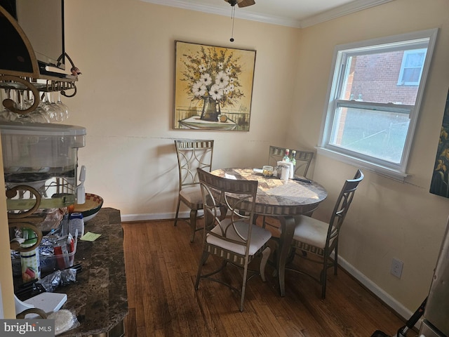 dining area with ceiling fan, crown molding, and dark wood-type flooring