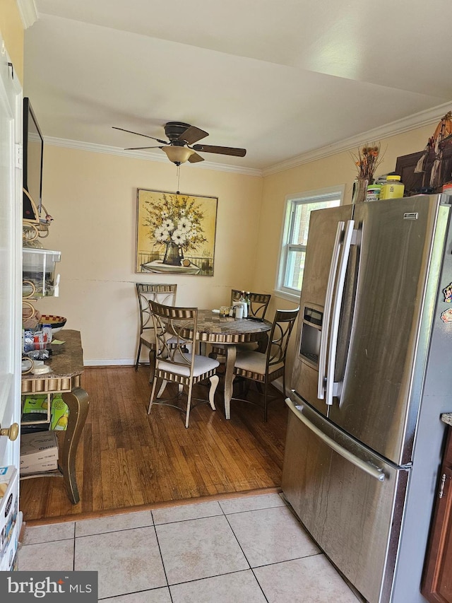 dining area with ceiling fan, light hardwood / wood-style floors, and ornamental molding