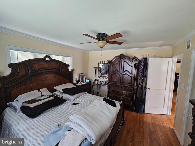 bedroom featuring ceiling fan, dark hardwood / wood-style flooring, and ornamental molding