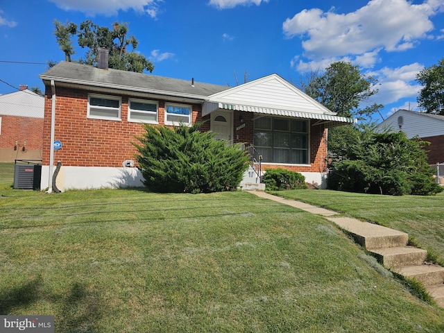 bungalow with cooling unit and a front yard