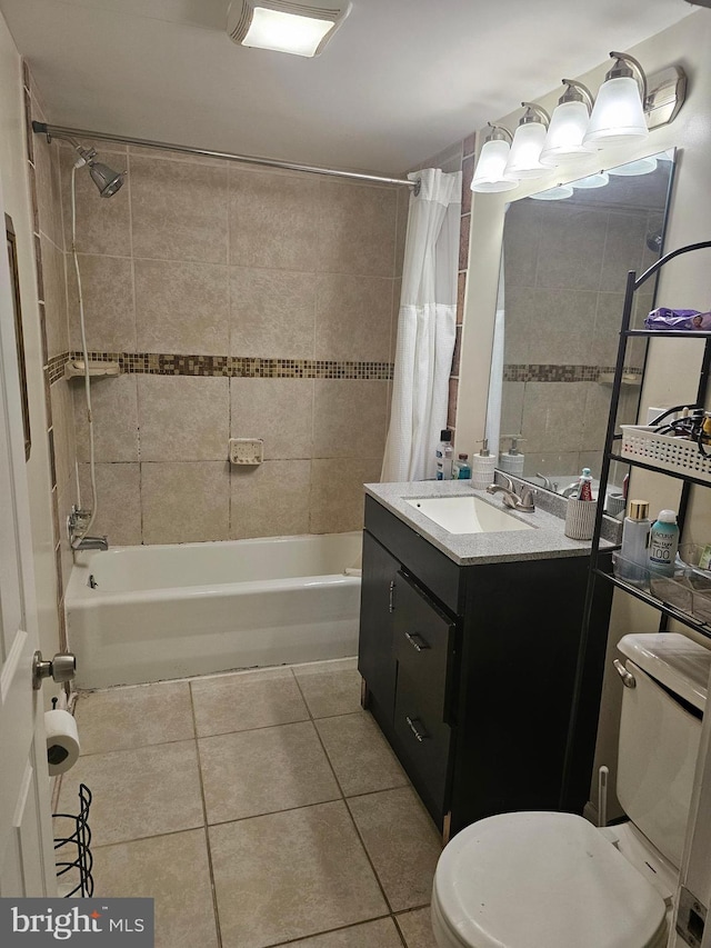 full bathroom with tile patterned flooring, shower / tub combo, vanity, and toilet