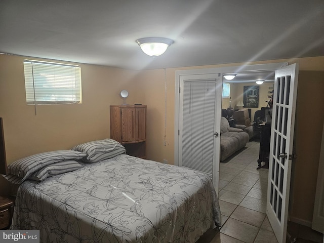 bedroom with light tile patterned floors and a closet