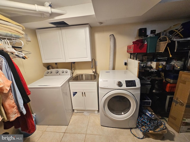 washroom with cabinets, independent washer and dryer, sink, and light tile patterned floors