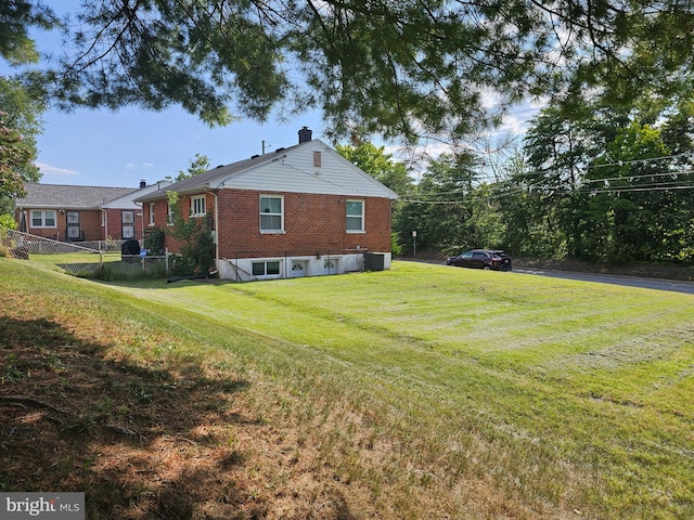 view of home's exterior featuring cooling unit and a yard