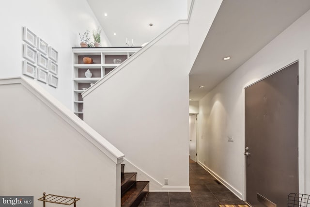 stairway with tile patterned floors