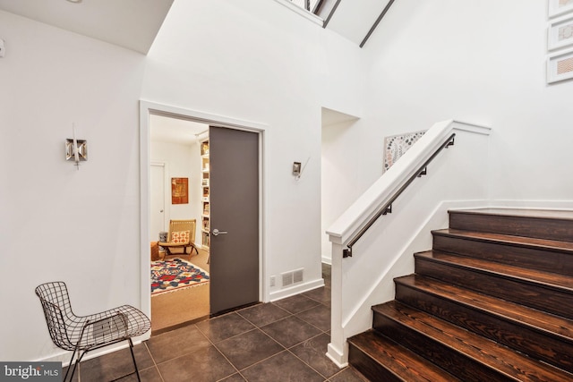 stairway featuring tile patterned floors