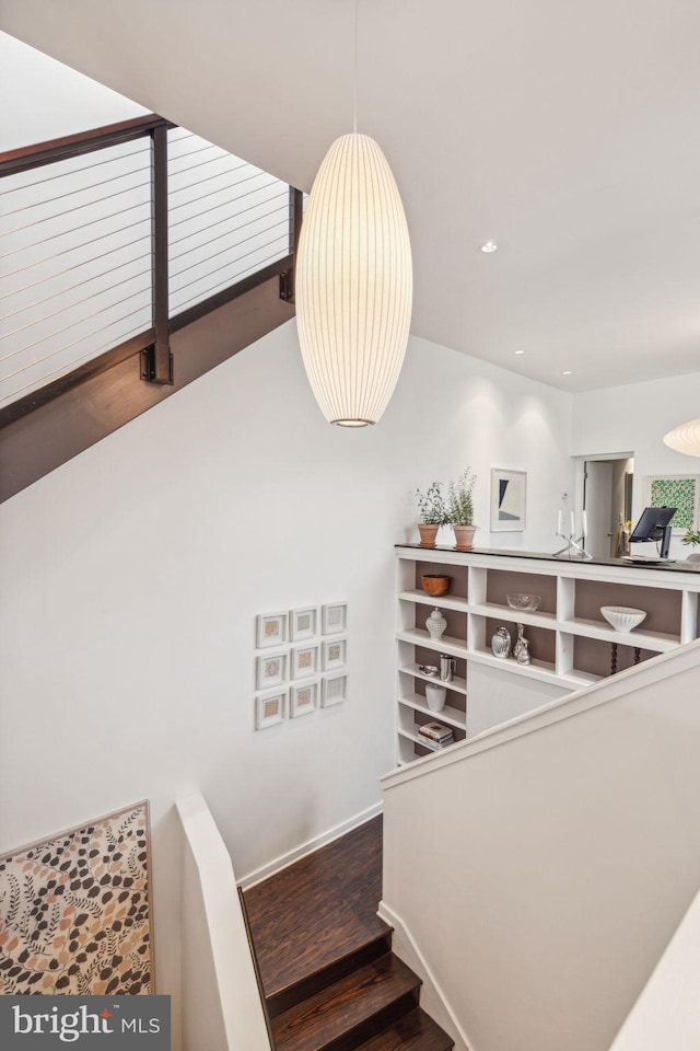 stairway with hardwood / wood-style floors