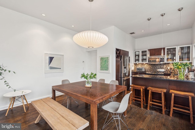 dining area featuring dark wood-type flooring