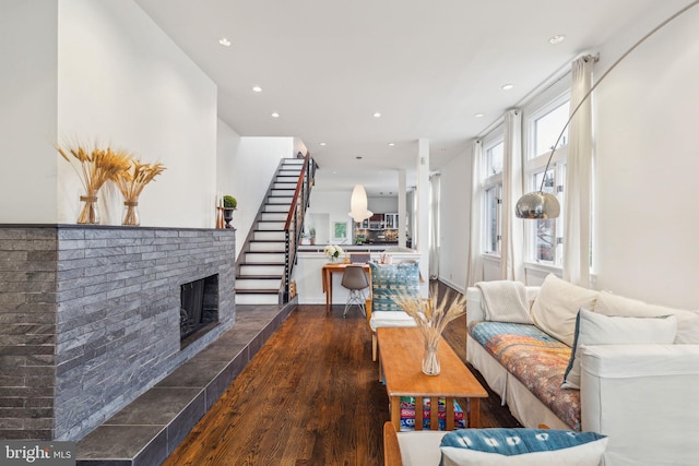 living room featuring a fireplace and dark hardwood / wood-style floors