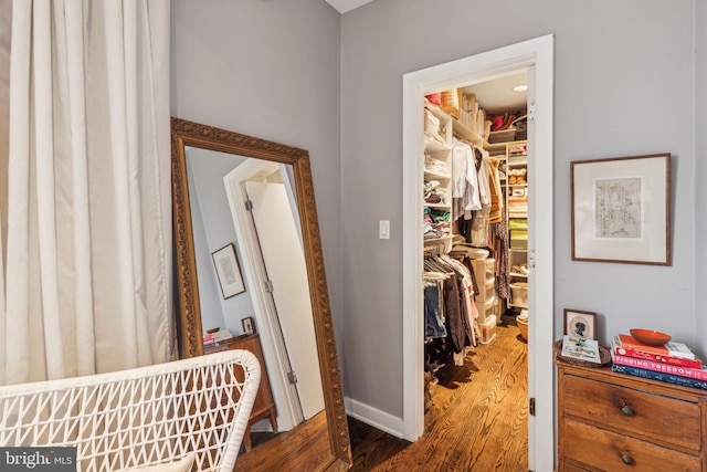 hall with hardwood / wood-style flooring