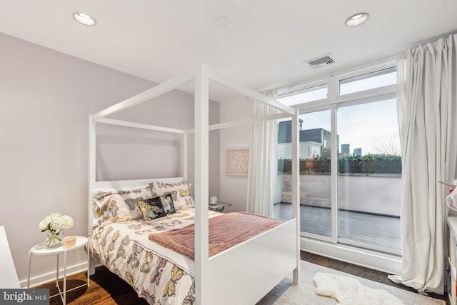 bedroom with dark hardwood / wood-style floors and access to outside