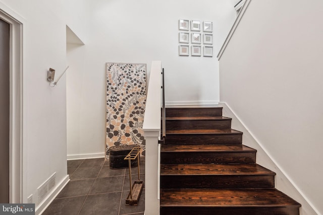 staircase featuring tile patterned floors