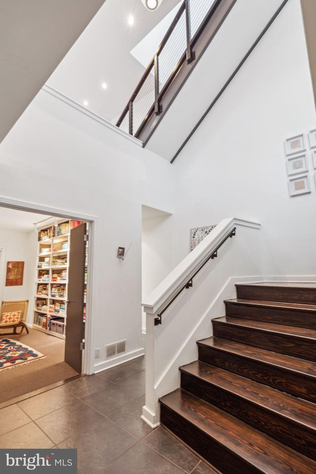 staircase featuring tile patterned floors