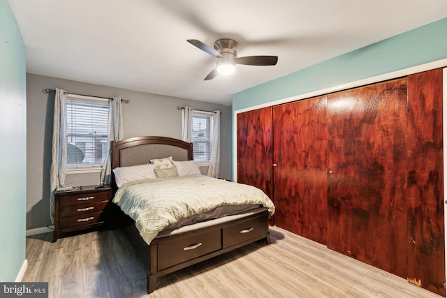 bedroom with wood-type flooring, multiple windows, and ceiling fan