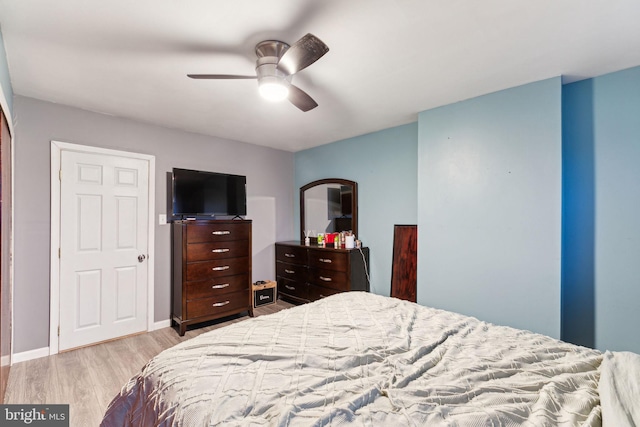 bedroom with ceiling fan and light hardwood / wood-style flooring