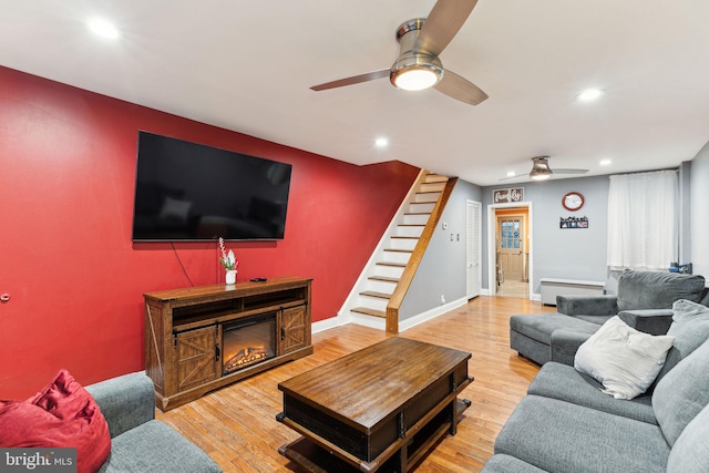 living room with baseboard heating and hardwood / wood-style floors