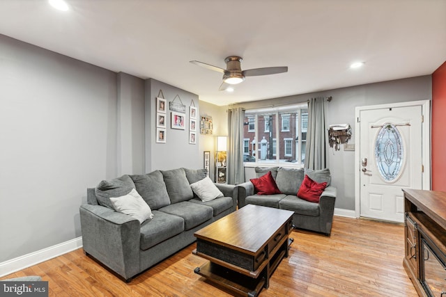 living room with ceiling fan and light wood-type flooring