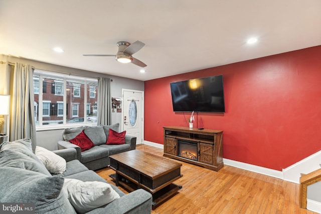 living room featuring ceiling fan and light wood-type flooring