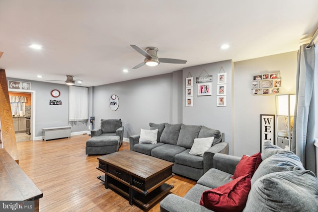 living room featuring ceiling fan and light hardwood / wood-style floors