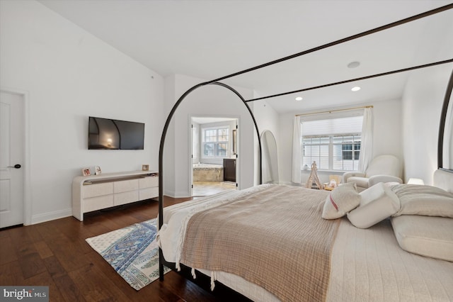 bedroom with multiple windows and dark wood-type flooring