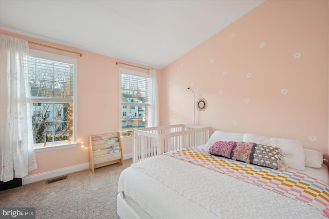 carpeted bedroom with vaulted ceiling