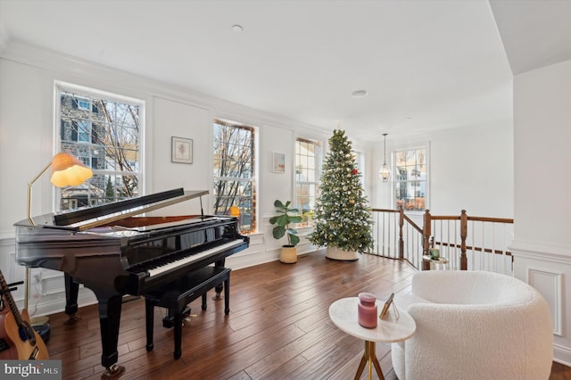 living area featuring crown molding, plenty of natural light, and dark wood-type flooring