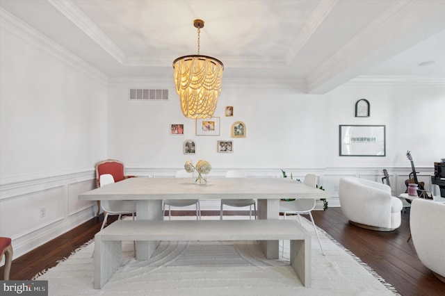 dining area featuring a chandelier, dark hardwood / wood-style flooring, a tray ceiling, and ornamental molding