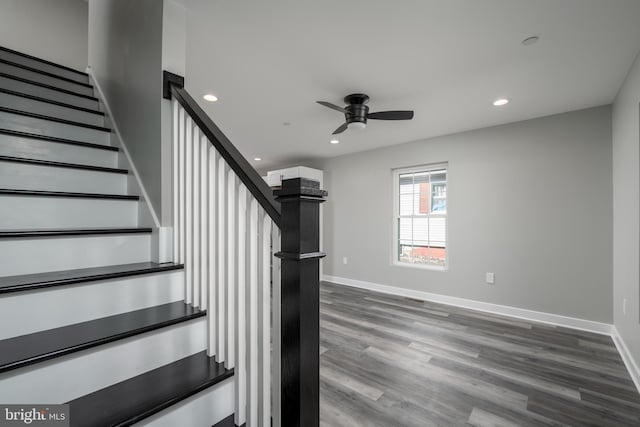 stairs with hardwood / wood-style flooring and ceiling fan