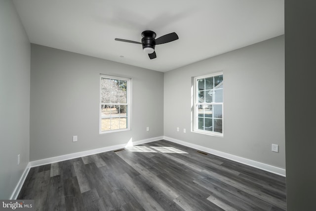 empty room featuring ceiling fan and dark wood-type flooring