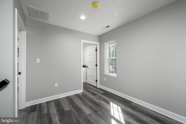 unfurnished room featuring dark hardwood / wood-style floors