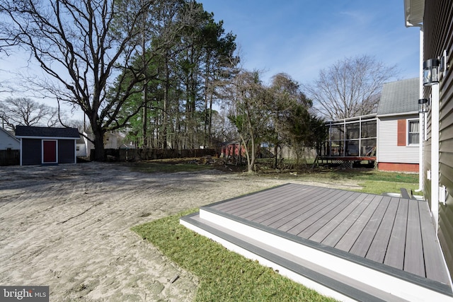 view of yard featuring a deck and a shed