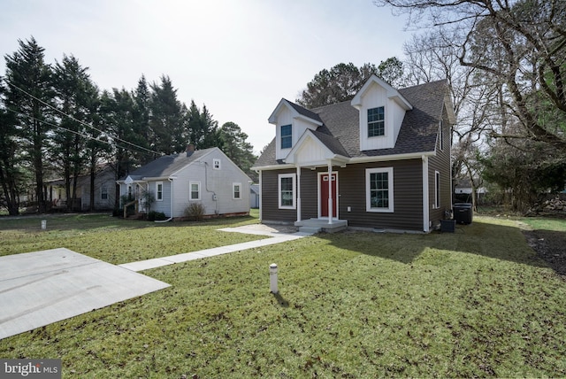 cape cod house with a front yard