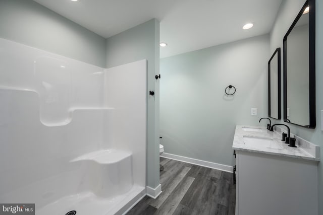 bathroom with vanity, toilet, and hardwood / wood-style floors