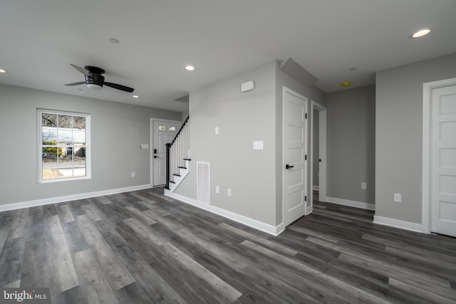 unfurnished living room featuring ceiling fan and dark hardwood / wood-style floors