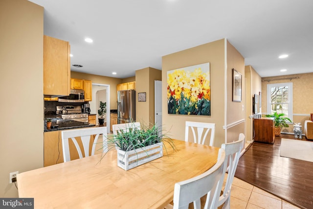 dining space featuring light tile patterned floors