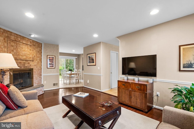 living room with hardwood / wood-style flooring and a fireplace