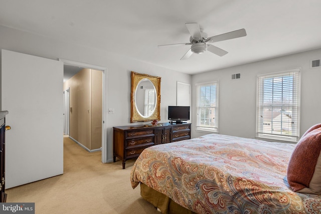 bedroom featuring light carpet and ceiling fan